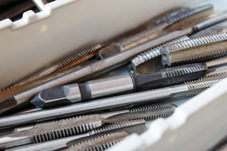 Set of machine taps in the storage boxの写真素材