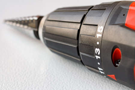 Screwdriver closeup with a stepped drill bit