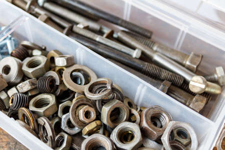 Old nuts and bolts in a storage box