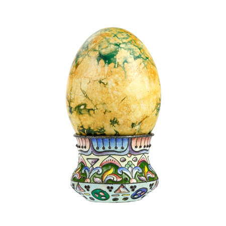 Easter egg in holder isolated on white backgroundの写真素材