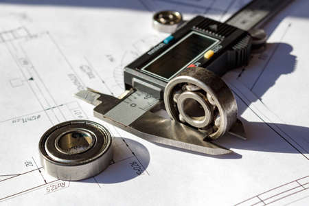 Measuring of the used ball bearings height by electronic caliperの写真素材