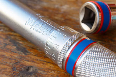Torque wrench on a wooden table in the workshop closeup