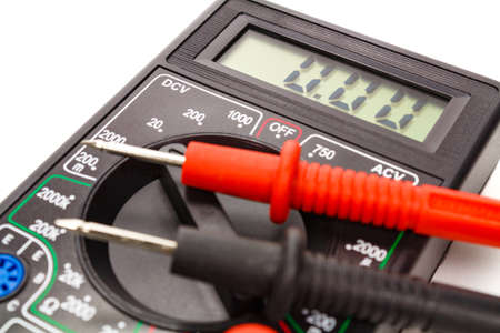 Digital multimeter with probes on a white background