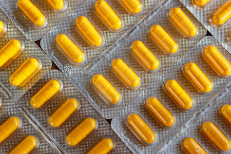 Yellow pills in a blister pack closeupの写真素材