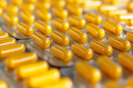 Yellow pills in a blister pack closeupの写真素材