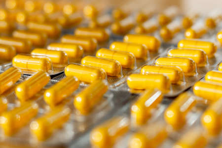 Yellow pills in a blister pack closeupの写真素材