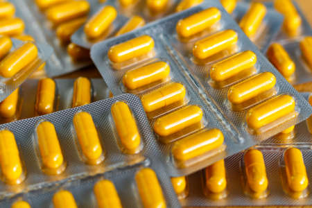 Yellow pills in a blister pack closeupの写真素材