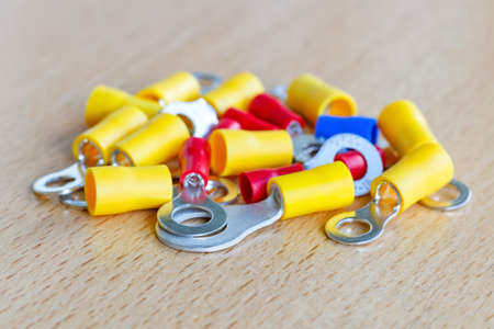 Colored circular pre-insulated cord ends on the table closeupの写真素材