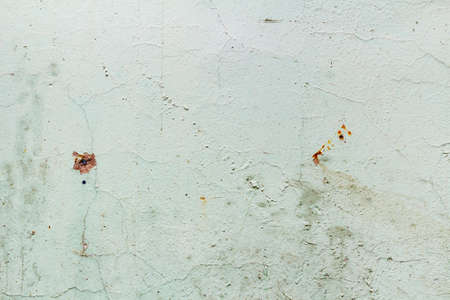 Green painted concrete wall texture with damaged and scratched surface. Abstract background