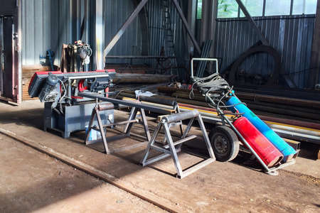Gas welding equipment and band saw in the assembly shop