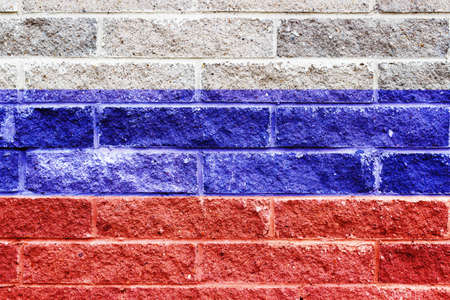 Russian flag painted on a gray stone bricks wallの写真素材