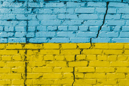 Ukrainian flag painted on a brick wall. Flag of Ukraine. Textured abstract background