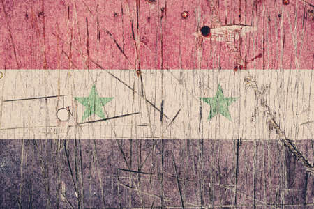 Syrian flag painted on a weathered wooden board. Flag of Syria. Textured abstract backgroundの写真素材