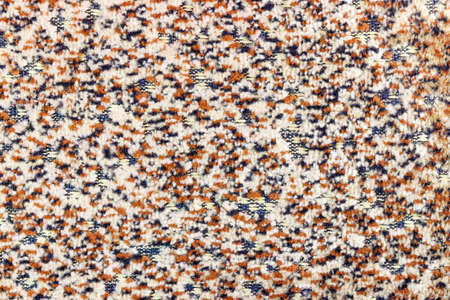 Abstract texture of woolen fabric with brown and black dots. Natural fabric background
