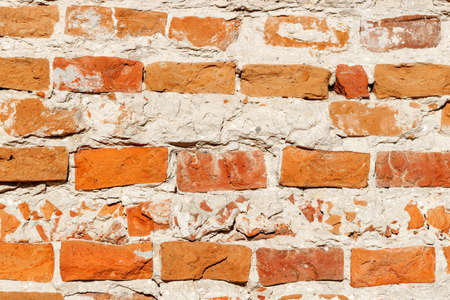 Texture of the old weathered brick wall closeup. Abstract background