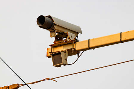 Traffic control camera on a pillar above the roadの写真素材
