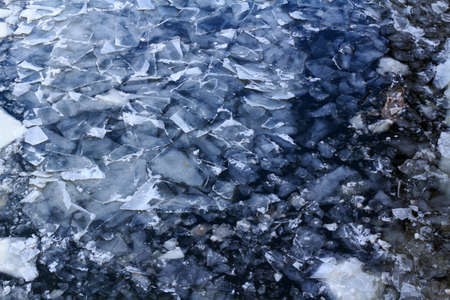 Broken ice on the surface of the river in winter. Ice floes textureの写真素材