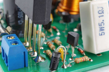 Printed circuit board with installed analogue electronic components closeup