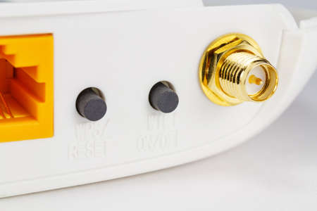 Antenna connector and control buttons on the back panel of the router closeup