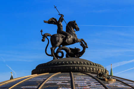 Moscow, Russia - May 27, 2018: Sculpture of Saint George the Victorious on the dome of World Clock...