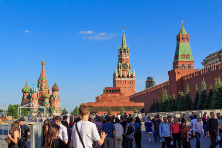 Moscow, Russia - May 27, 2018: Tourists walk on Red square near the Moscow Kremlin in sunny evening