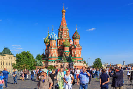 Moscow, Russia - May 27, 2018: Tourists walk on Red square on a St. Basil's Cathedral background in sunny eveningのeditorial素材