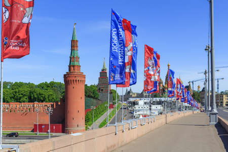 Moscow, Russia - June 03, 2018: Waving flags with symbols of FIFA World Cup Russia 2018 on Bol'shoy Moskvoretskiy bridge on a background of Moscow Kremlin towersのeditorial素材