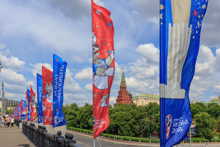 Moscow, Russia - June 03, 2018: Waving flags with symbols of FIFA World Cup Russia 2018 on Bol'shoy Kamennyy bridge on a background of Moscow Kremlin towerのeditorial素材