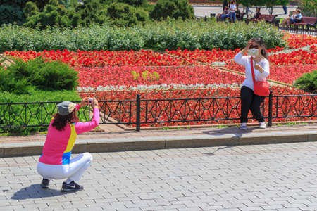 Moscow, Russia - June 03, 2018: Tourists take photos in Alexandrovsky Garden in Moscow on a sunny...