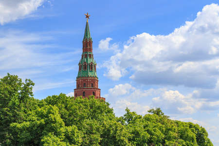 Vodovzvodnaya tower of Moscow Kremlin on a green trees and blue sky background in sunny summer dayの写真素材