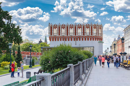 Moscow, Russia - June 03, 2018: Tourists walk on Manezhnaya Square against Alexandrovsky Garden and Kutafiya Tower of Moscow Kremlin in sunny summer morningのeditorial素材