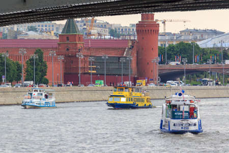 Moscow, Russia - June 19, 2018: Pleasure boats floating on a background of Moscow Kremlin on a cloudy summer eveningのeditorial素材