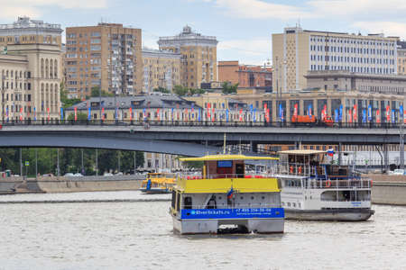 Moscow, Russia - June 21, 2018: Pleasure boats floating against of bridge over Moskva river and buildings on a summer dayのeditorial素材