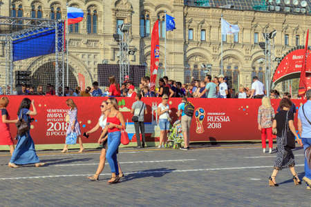 Moscow, Russia - June 28, 2018: Tourists in Football Park on Red square on a background of GUM Department store in sunny summer eveningのeditorial素材