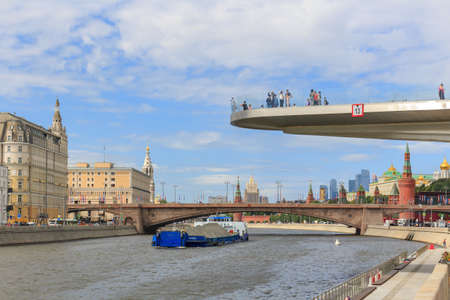 Moscow, Russia - June 21, 2018: Soaring bridge in Zaryadye Park on a background of Moskva river embankment in sunny summer morningのeditorial素材