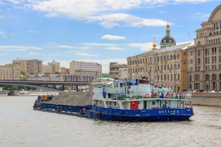 Moscow, Russia - June 21, 2018: Loaded barge floating in the center of Moscow on Moskva riverのeditorial素材