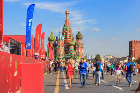 Moscow, Russia - June 28, 2018: Tourists walking near Football Park on Red square on a background of St. Basil's Cathedral in sunny summer eveningのeditorial素材