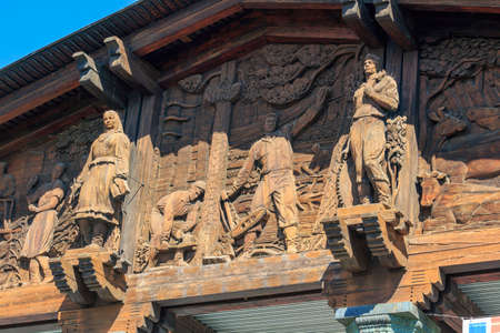 Moscow, Russia - August 01, 2018: Wooden monumental reliefs dedicated to main sectors of national economy of Karelia on facade of pavilion Karelia on VDNH in Moscowのeditorial素材