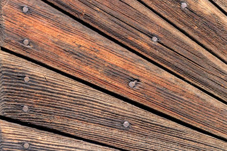 Vintage wooden wall texture. Weathered wooden boards with nails closeup