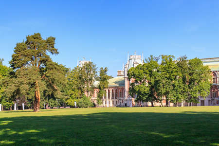 Moscow, Russia - August 12, 2018: Green lawn with trees in front of Great Palace in Museum-reserve Tsaritsyno on a sunny summer morningのeditorial素材