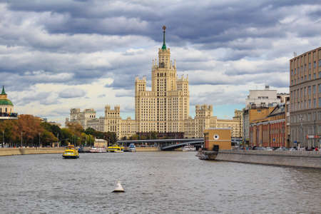 Moscow, Russia - September 30, 2018: Embankments of Moskva river against Stalin skyscraper in cloudy...
