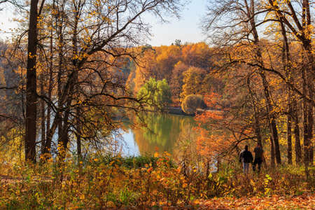 Moscow, Russia - October 17, 2018: View of pond in Tsaritsyno park in Moscow on a background of trees with colored leaves on the shore at sunny autumn dayのeditorial素材