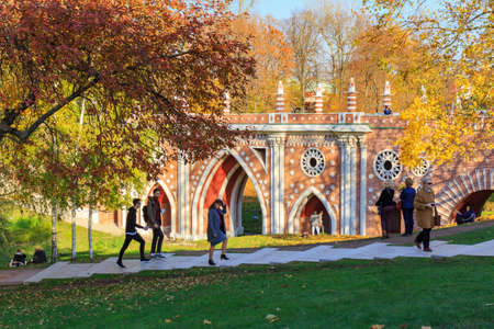 Moscow, Russia - October 17, 2018: People walking on the granite stairs on a background of Great bridge over the ravine in Tsaritsyno park in Moscow at sunny autumn dayのeditorial素材