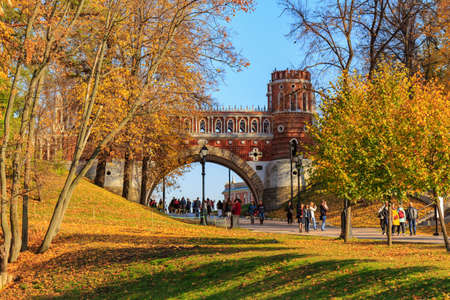 Moscow, Russia - October 17, 2018: Figured bridge on a background of blue sky and green lawn at sunny autumn day in Tsaritsyno park in Moscowのeditorial素材