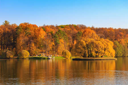 Moscow, Russia - October 17, 2018: View of pond and trees with golden leaves on shore in Tsaritsyno park in Moscow at sunny autumn dayのeditorial素材