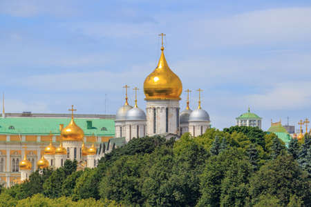 Moscow, Russia - June 21, 2018: Golden domes of cathedrals in the Moscow Kremlin against green trees and blue skyのeditorial素材