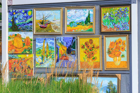 Moscow, Russia - July 30, 2018: Paintings by contemporary artists near New Tretyakov Gallery in Moscow on a background of green grassのeditorial素材