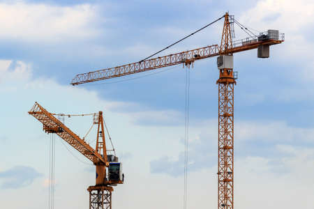 High-rise construction cranes on a blue sky backgroundの写真素材