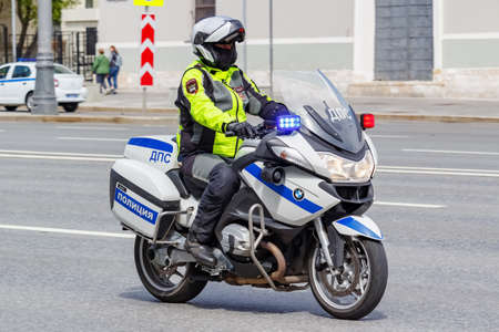 Moscow, Russia - May 04, 2019: Police on modern BMW motorcycle with flashing red and blue lights ride the street in sunny dayのeditorial素材