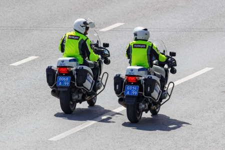 Moscow, Russia - May 04, 2019: Police on modern BMW motorcycles with flashing red and blue lights...
